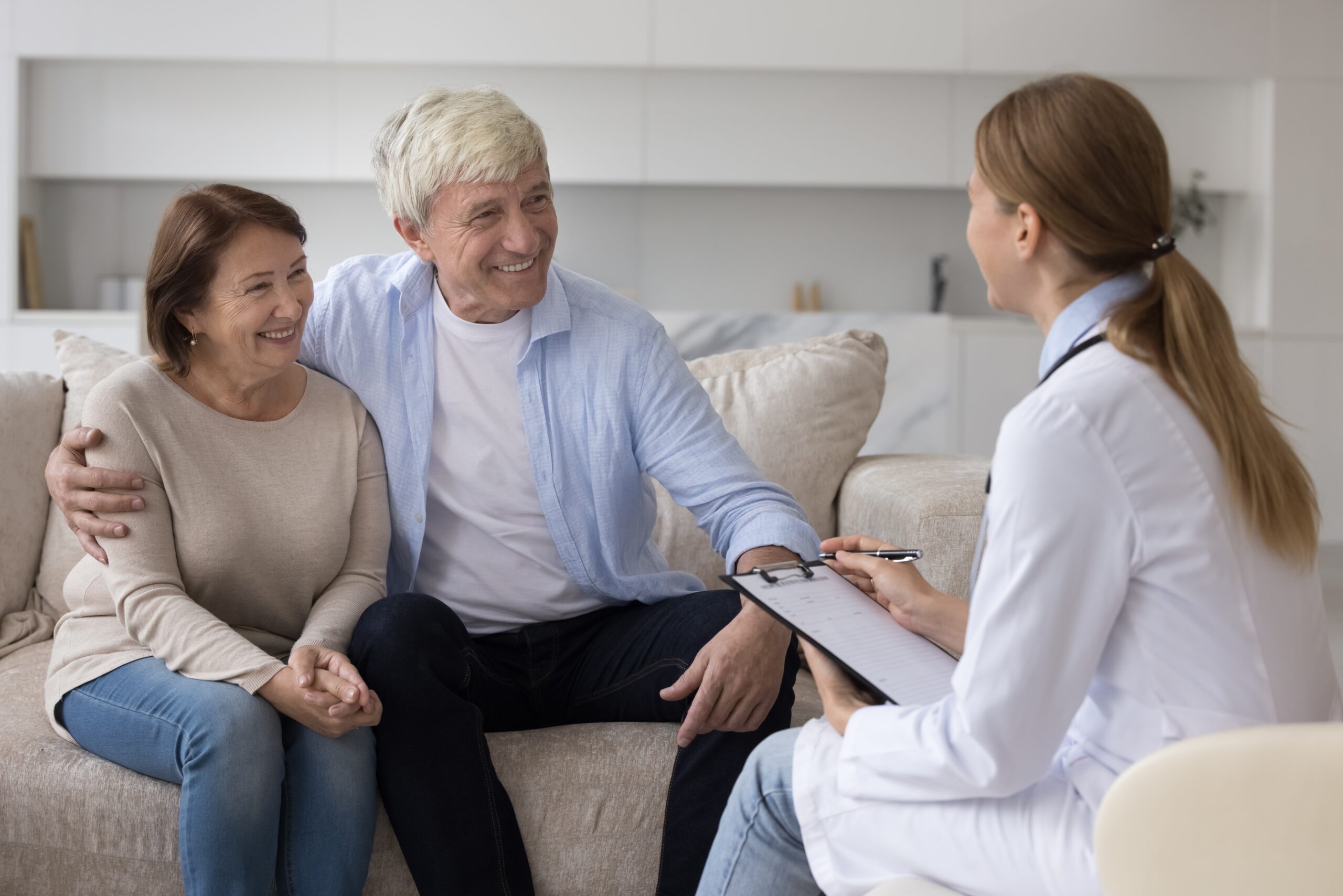 Older couple talking to doctor about medical coverage